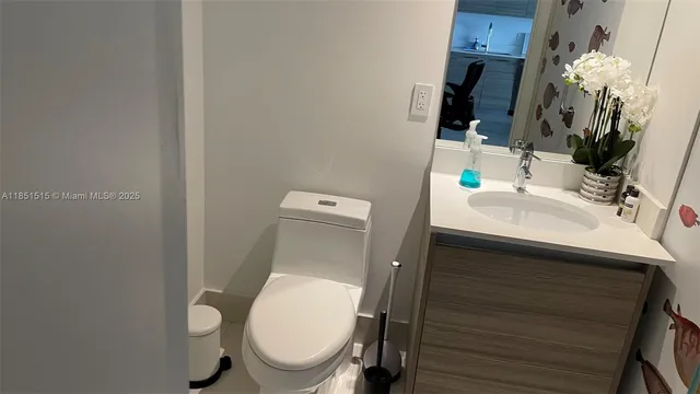 a bathroom with a toilet sink and mirror