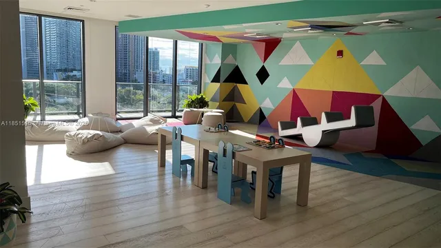 a living room with furniture a wooden floor and next to a window