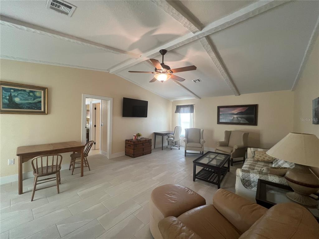 2533 Rio Tiber Drive Punta Gorda, FL 33950 - Photo 13 of 43 a living room with furniture a ceiling fan and a window