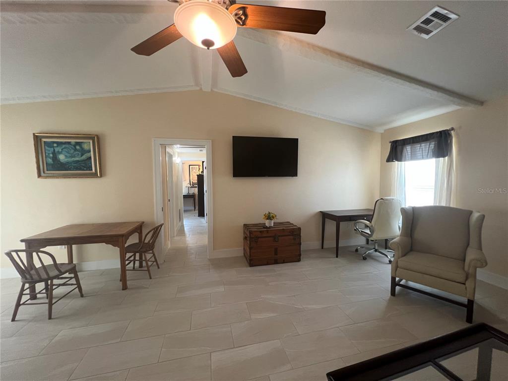 2533 Rio Tiber Drive Punta Gorda, FL 33950 - Photo 16 of 43 a living room with furniture a flat screen tv and a window