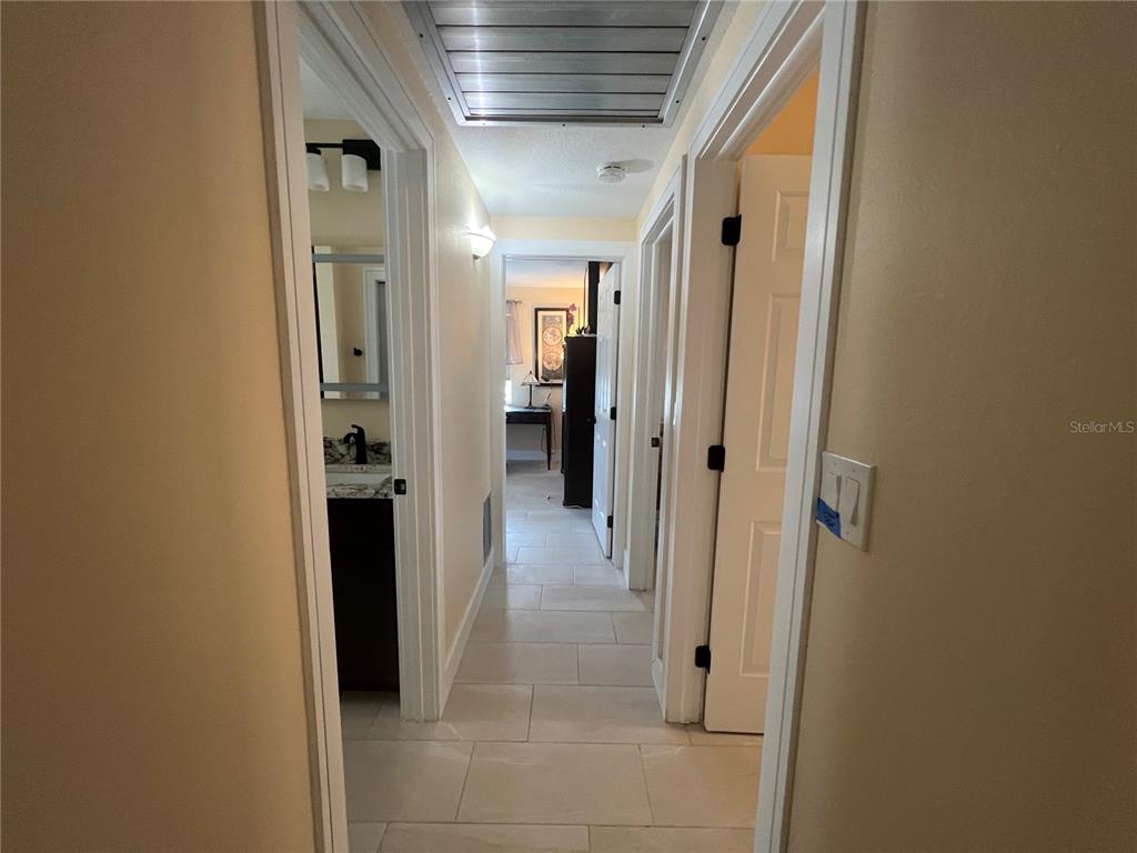 2533 Rio Tiber Drive Punta Gorda, FL 33950 - Photo 18 of 43 a view of a hallway with wooden shelves