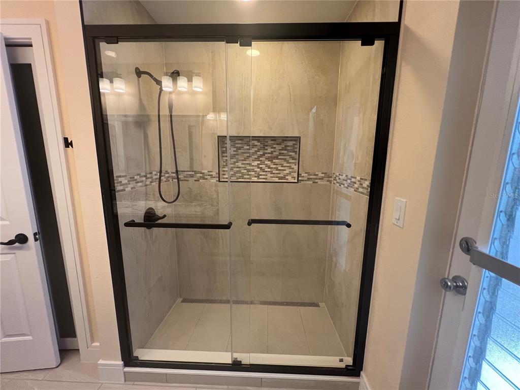 2533 Rio Tiber Drive Punta Gorda, FL 33950 - Photo 20 of 43 a bathroom with a glass shower door