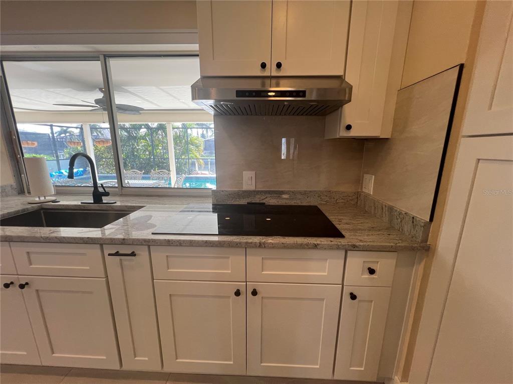 2533 Rio Tiber Drive Punta Gorda, FL 33950 - Photo 30 of 43 a view of a kitchen sink with wooden floor