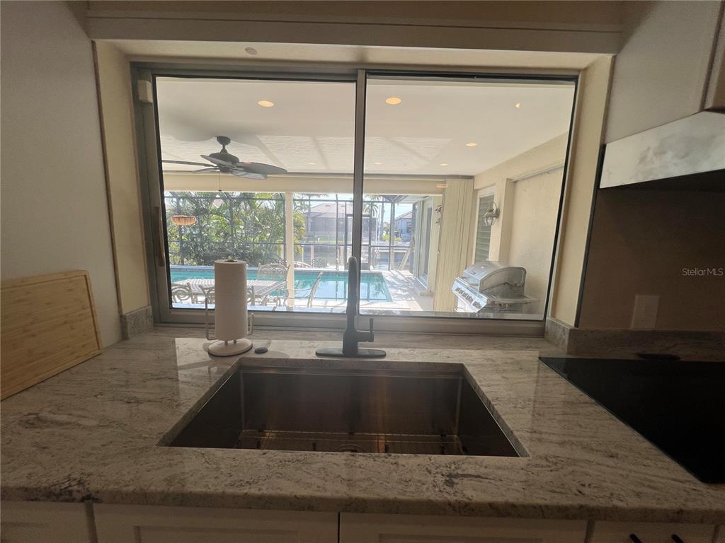 2533 Rio Tiber Drive Punta Gorda, FL 33950 - Photo 31 of 43 a kitchen with granite countertop a sink and a window