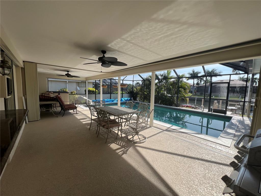 2533 Rio Tiber Drive Punta Gorda, FL 33950 - Photo 36 of 43 a view of a patio with table and chairs next to a yard