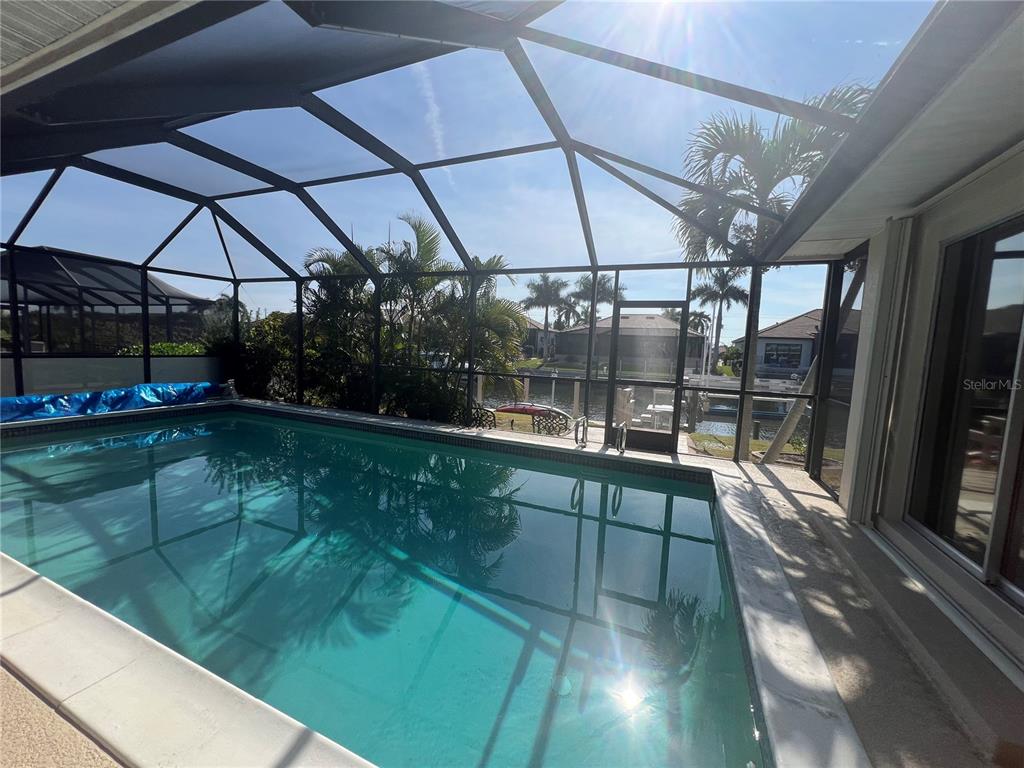 2533 Rio Tiber Drive Punta Gorda, FL 33950 - Photo 37 of 43 a view of a swimming pool with a patio and a yard