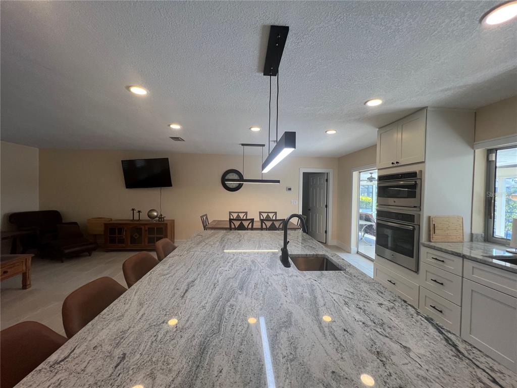 2533 Rio Tiber Drive Punta Gorda, FL 33950 - Photo 6 of 43 a large kitchen with stainless steel appliances kitchen island a large counter top a stove and a sink