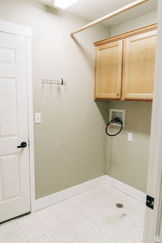 1825 West Mathis Park Place, Unit 40 St. George, UT 84770 - Photo 26 of 28 Laundry room featuring light flooring, hookup for a washing machine, and cabinet space
