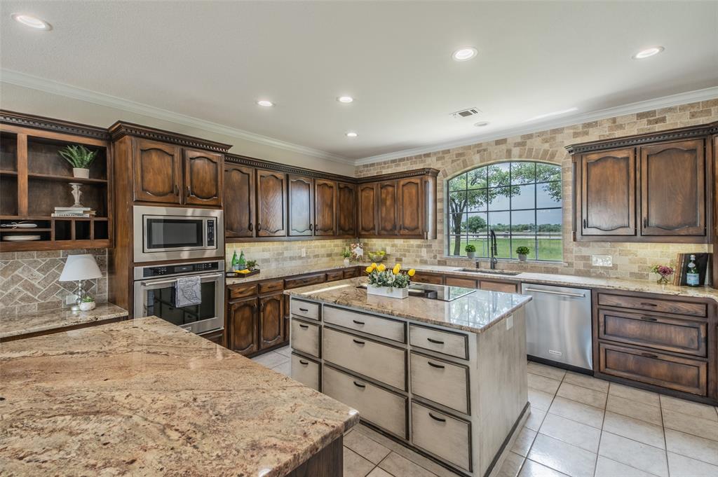 13507 Friendship Road Pilot Point, TX 76258 - Photo 11 of 39 a kitchen with a stove sink and microwave