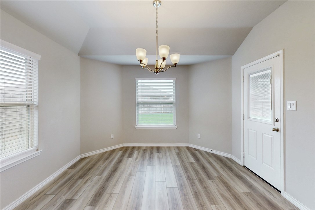 2010 Chief Street Bryan, TX 77807 - Photo 19 of 29 a view of a room with wooden floor exposed radiator and windows