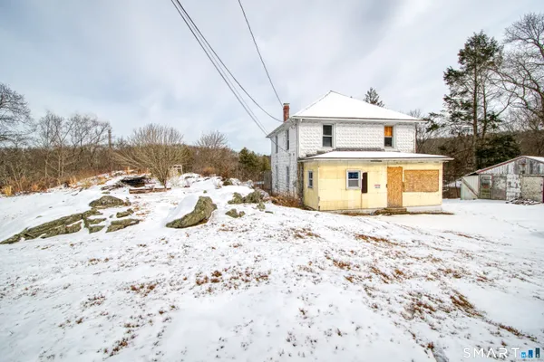 a view of a house with a snow in the yard