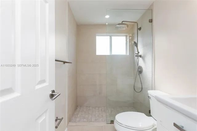 a bathroom with a toilet and a shower