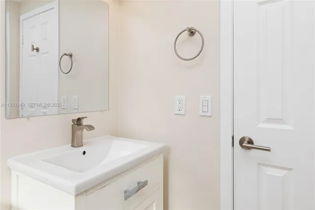 a bathroom with a sink and mirror