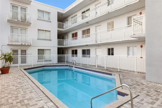 a view of a patio with table and chairs potted plants