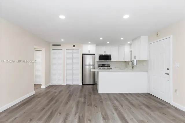 a view of kitchen with wooden floor