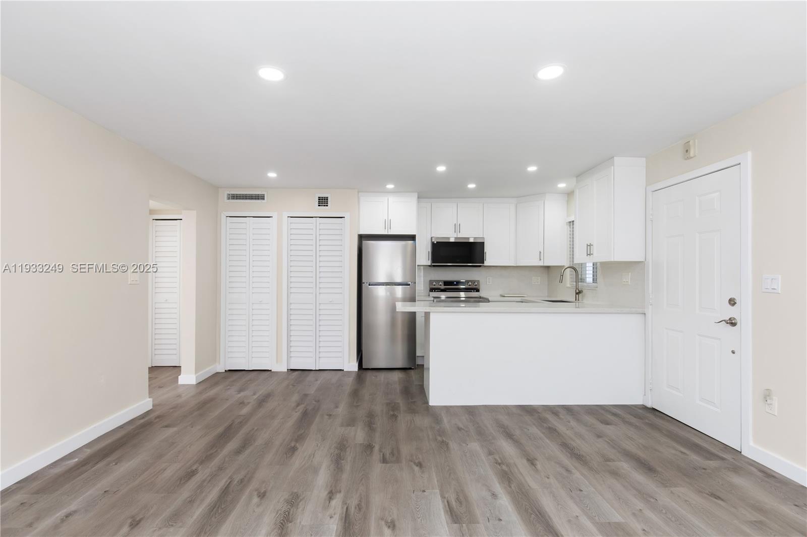 3101 Southwest 27th Avenue, Unit 204 Miami, FL 33133 - Photo 8 of 44 a view of kitchen with wooden floor