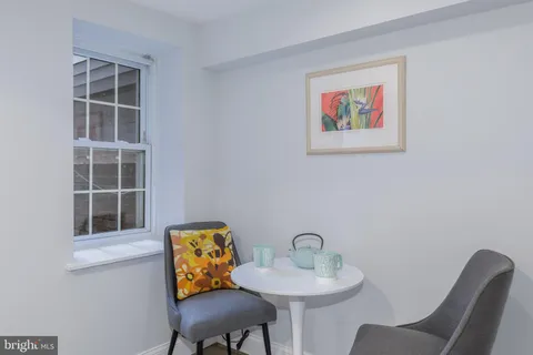 a view of living room with furniture and wooden floor