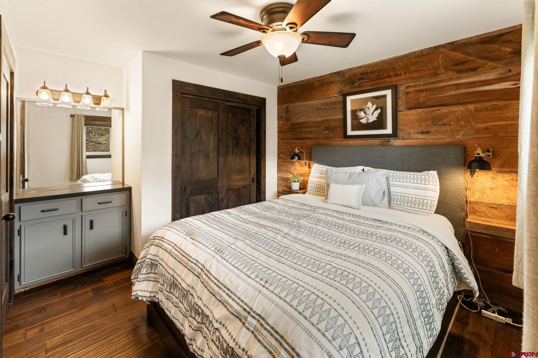18 Crystal Road, Unit 5B Crested Butte, CO 81225 - Photo 12 of 25 a bedroom with a bed and a chandelier