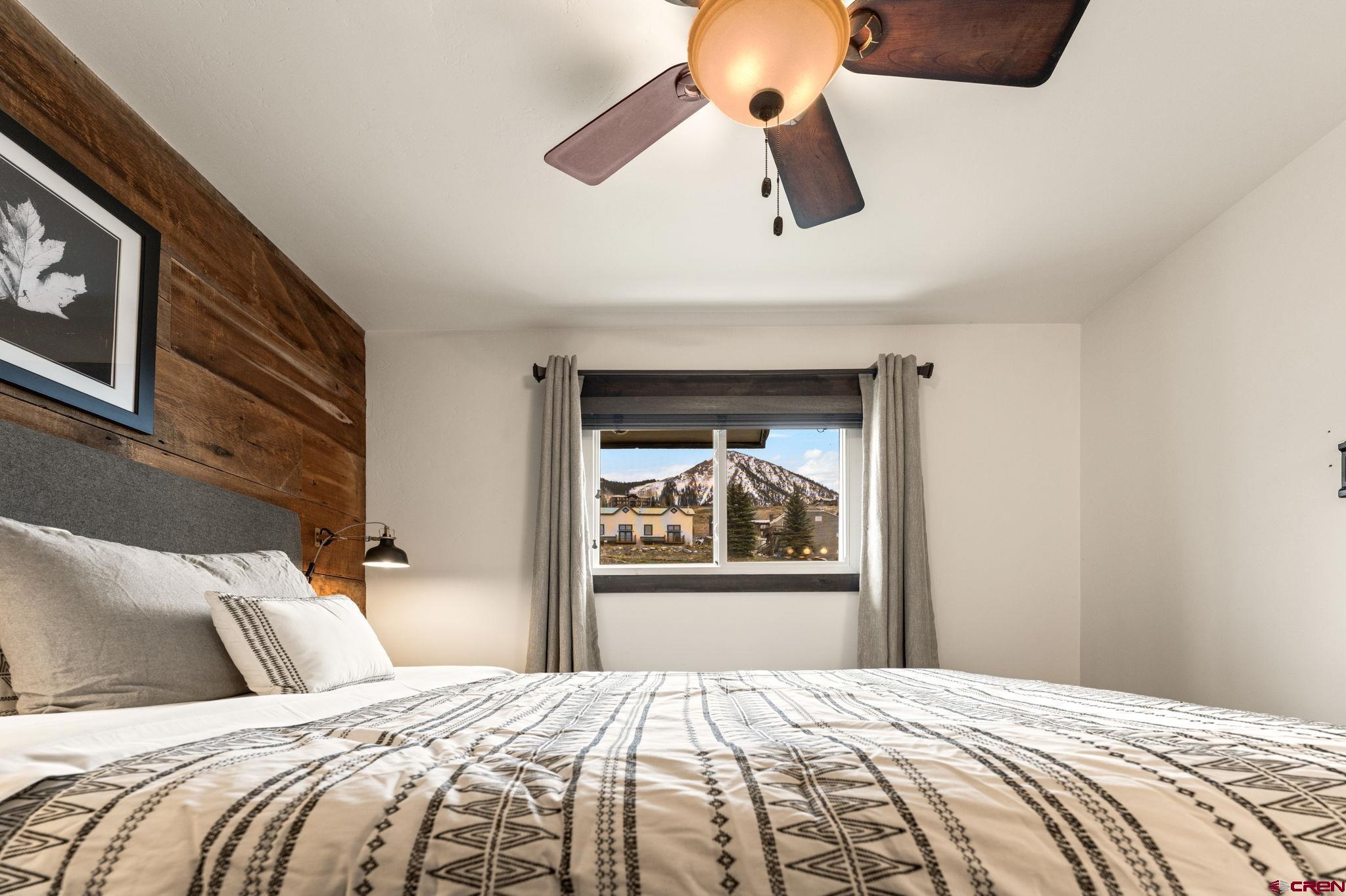 18 Crystal Road, Unit 5B Crested Butte, CO 81225 - Photo 13 of 25 a bedroom with a large bed and a painting on the wall