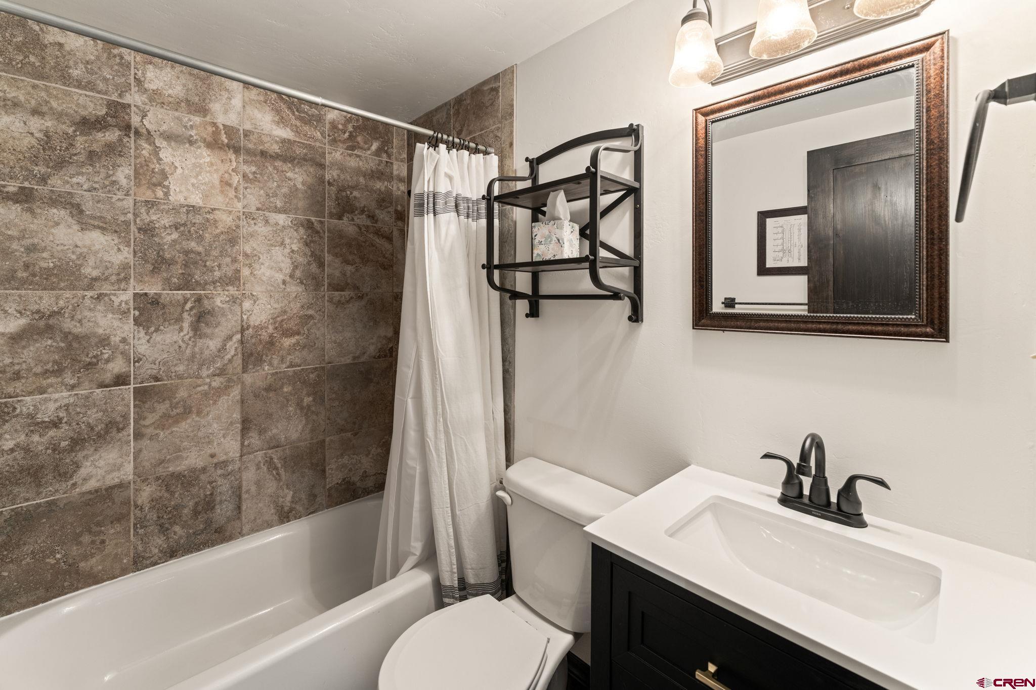 18 Crystal Road, Unit 5B Crested Butte, CO 81225 - Photo 17 of 25 a bathroom with a sink toilet and shower