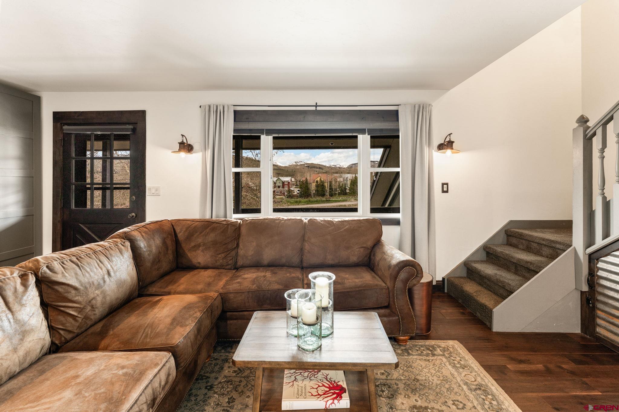 18 Crystal Road, Unit 5B Crested Butte, CO 81225 - Photo 2 of 25 a living room with furniture and a large window