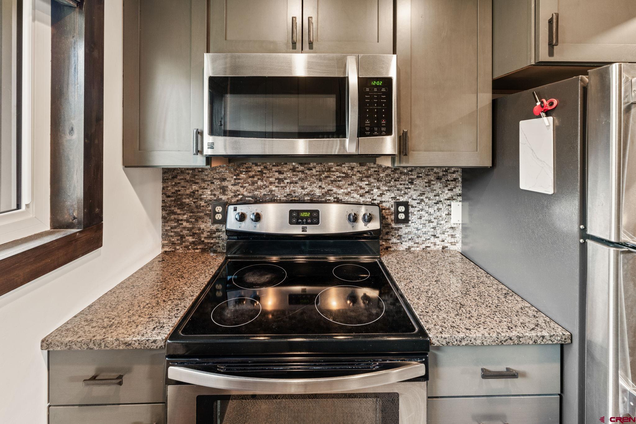18 Crystal Road, Unit 5B Crested Butte, CO 81225 - Photo 9 of 25 a kitchen with granite countertop a stove and a sink
