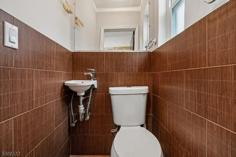 a bathroom with a toilet a sink and a mirror