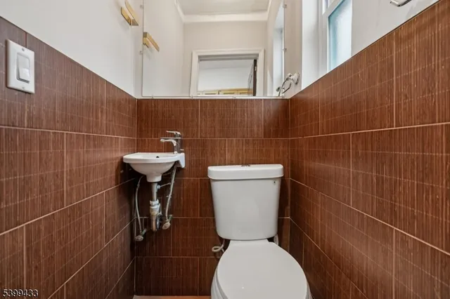 a bathroom with a toilet a sink and a mirror