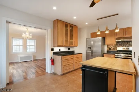 a kitchen with stainless steel appliances a sink stove and refrigerator