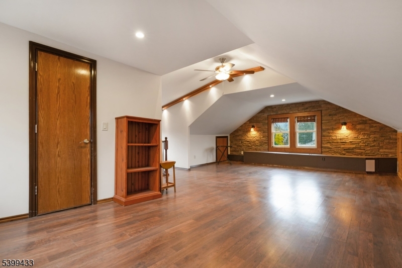 80 Locust Avenue Millburn, NJ 07041 - Photo 20 of 47 an empty room with wooden floor chandelier and windows