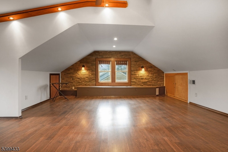 80 Locust Avenue Millburn, NJ 07041 - Photo 21 of 47 a view of an empty room with wooden floor and a window