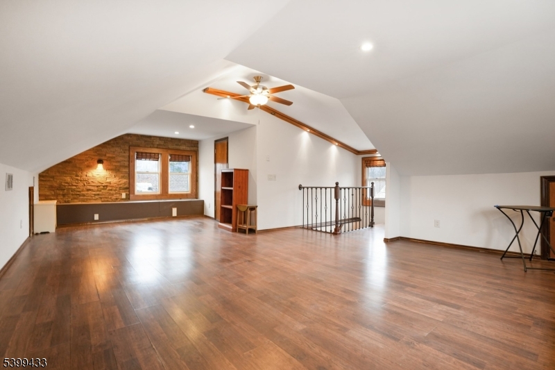 80 Locust Avenue Millburn, NJ 07041 - Photo 22 of 47 a view of a livingroom with wooden floor and a kitchen