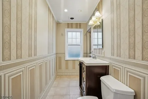 a bathroom with a sink a toilet and a mirror