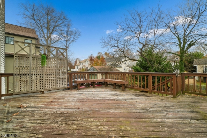 80 Locust Avenue Millburn, NJ 07041 - Photo 44 of 47 a view of a house with large trees and wooden fence