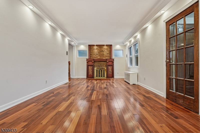 80 Locust Avenue Millburn, NJ 07041 - Photo 5 of 47 a view of empty room with wooden floor and fan