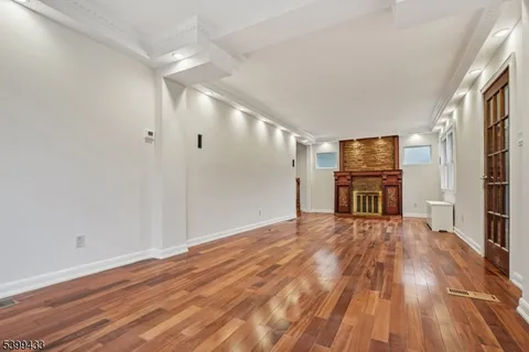 a view of a room with wooden floor and a window