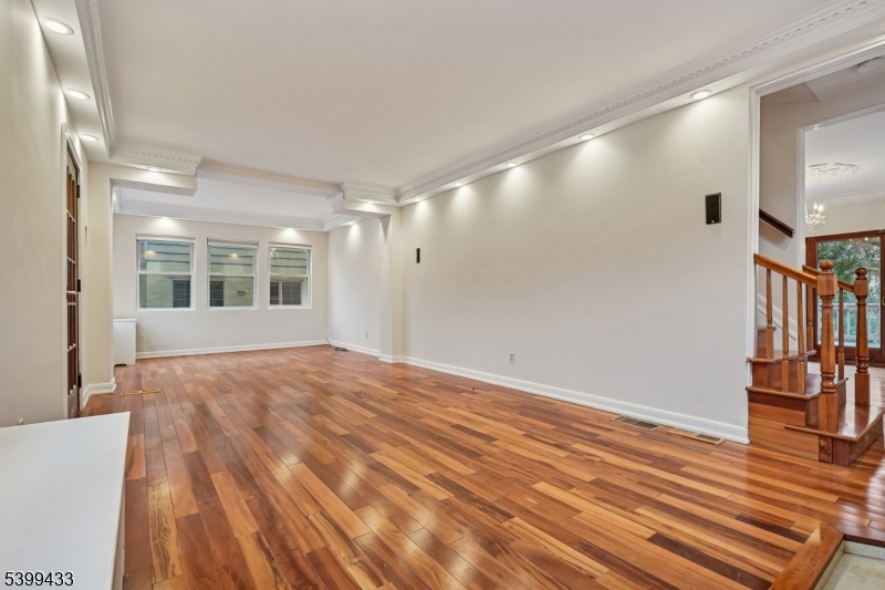 80 Locust Avenue Millburn, NJ 07041 - Photo 8 of 47 a view of an empty room with window and wooden floor