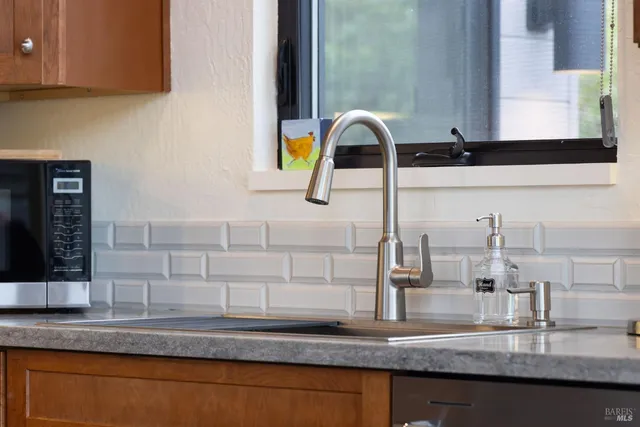 a kitchen with a sink cabinets and appliances