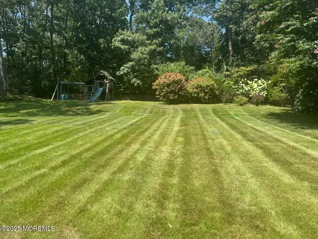 a view of a dining room with furniture a chandelier and wooden floor