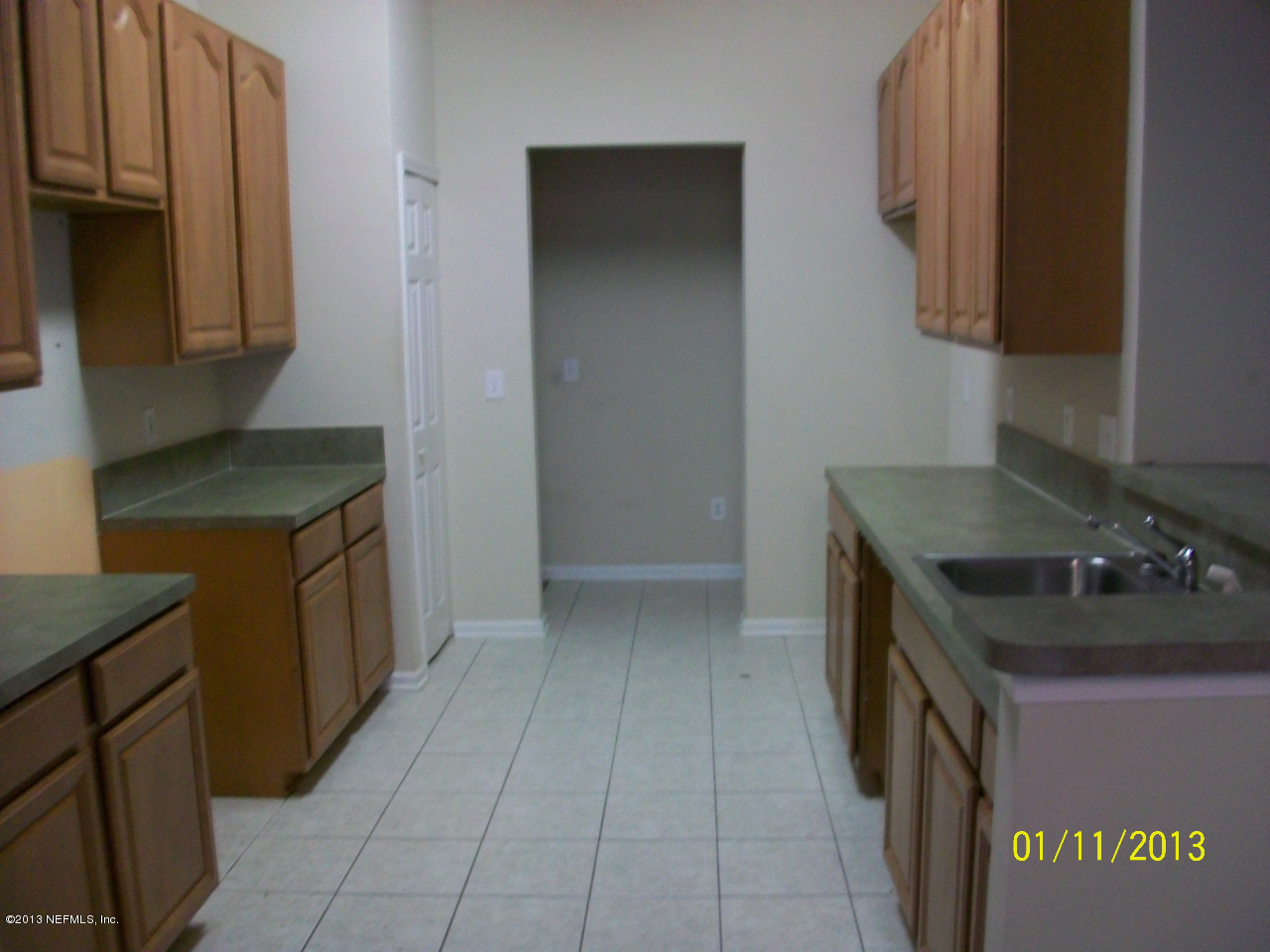 9400 Underwing Way, Unit 10 Jacksonville, FL 32257 - Photo 9 of 12 a kitchen with a sink stove and cabinets