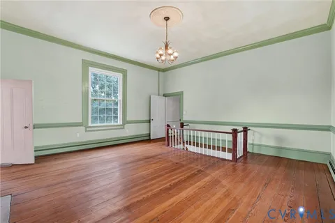 a view of a room with wooden floor and windows