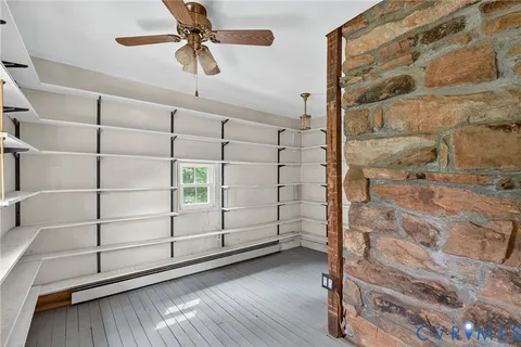 a view of a room with wooden floor and windows