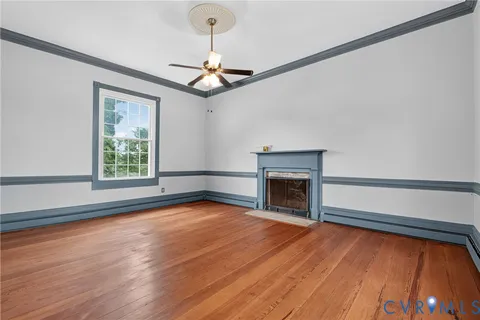 a view of a room with wooden floor and white walls