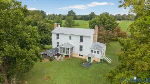 a view of a patio with table and chairs with wooden floor and fence
