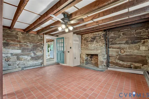 a front view of a house with a yard and potted plants