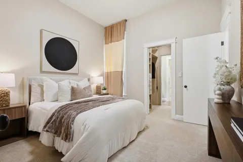a bedroom with a bed and a chandelier
