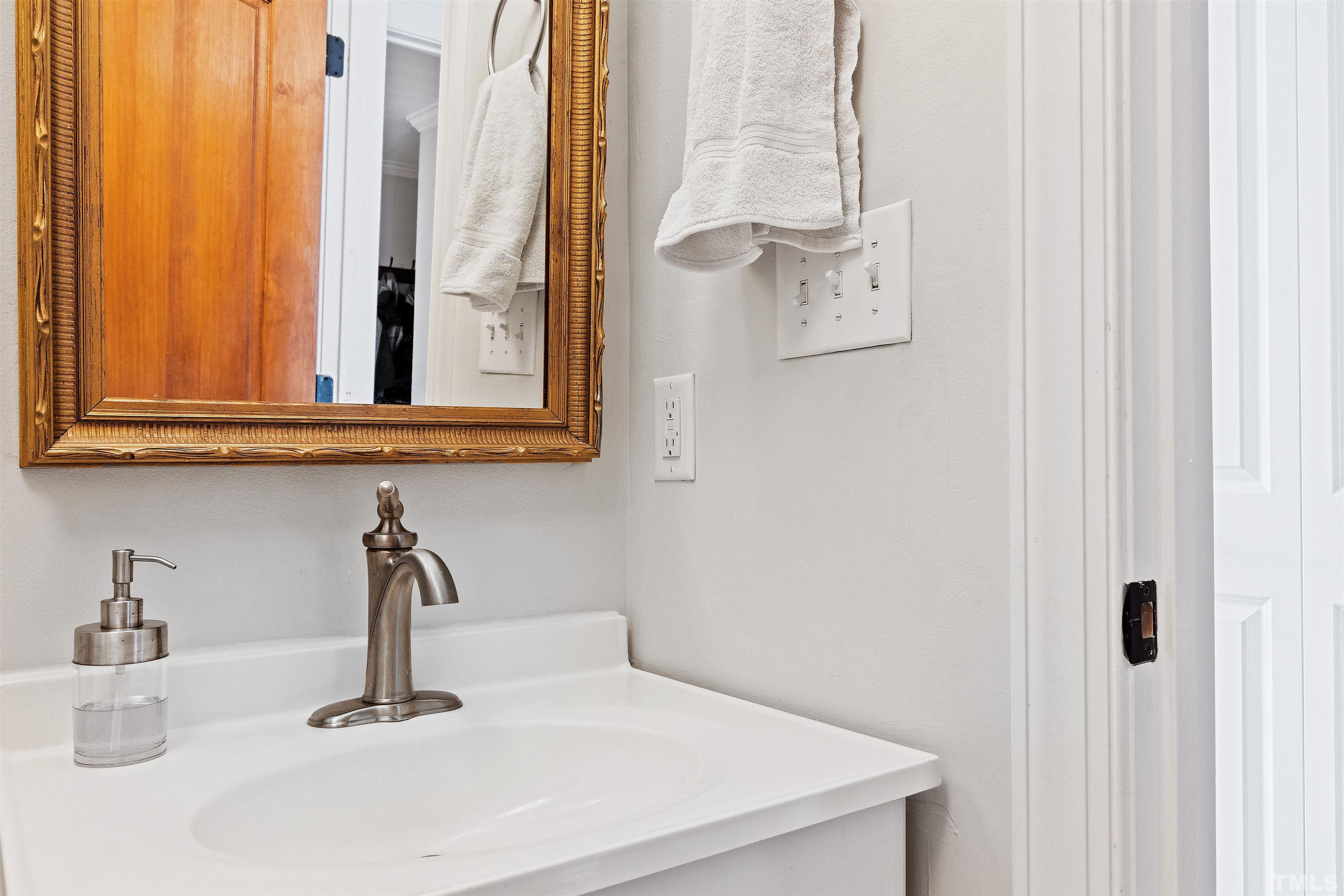 2960 Claremont Road Raleigh, NC 27608 - Photo 30 of 47 a bathroom with a sink and a mirror