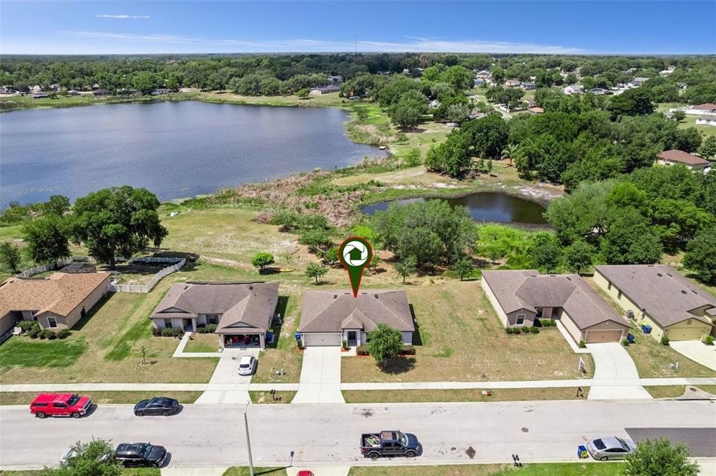 1613 Orne Street Mascotte, FL 34753 - Photo 26 of 31 an aerial view of residential houses with outdoor space and lake view