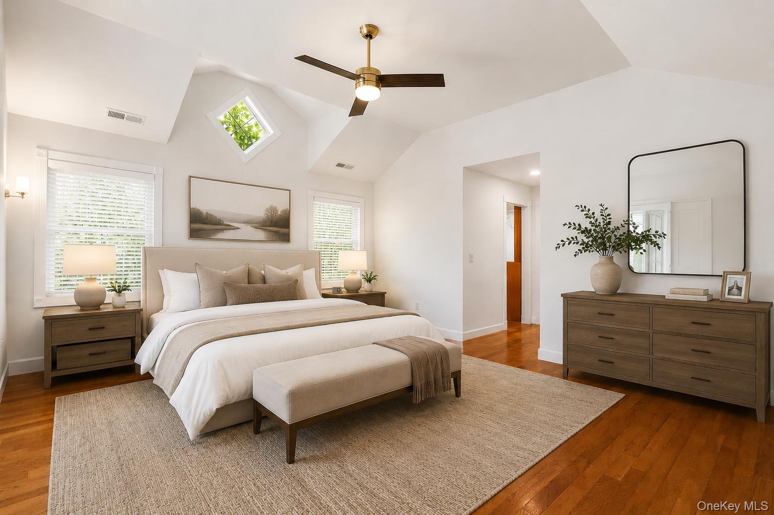 12 Leeside Road Carmel, NY 10512 - Photo 16 of 44 Spacious bedroom featuring vaulted ceilings, wood-finish flooring, and multiple windows including a prominent diamond-shaped window