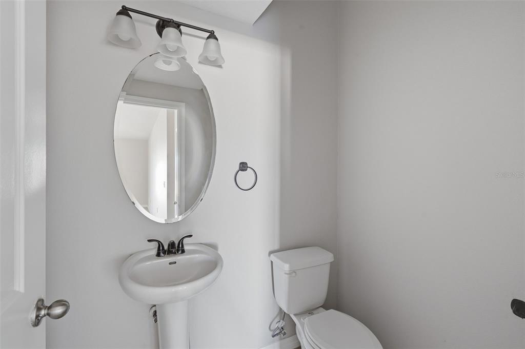 2318 Sebago Drive Lakeland, FL 33805 - Photo 17 of 54 a bathroom with a toilet sink and mirror